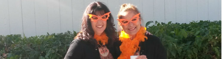 women with orange sunglasses posing for photo